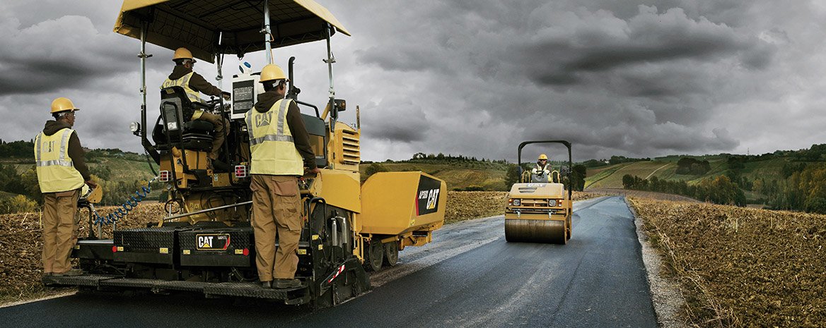 Road crew installing asphalt.